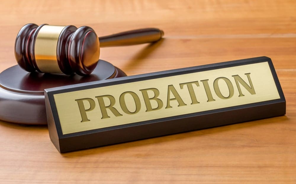 Image shows a courtroom gavel next to a probation nameplate, representing court decisions and supervision requirements in probation cases.