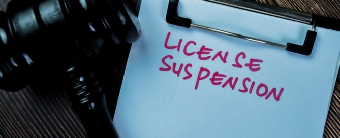Image is of a court clipboard and gavel highlighting DUI license suspension procedures and legal consequences tied to driving privileges.