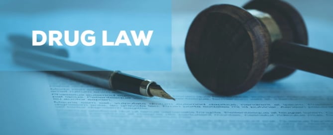 Image of a wooden gavel and fountain pen resting on a legal document, illustrating how drug schedules impact criminal defense cases.