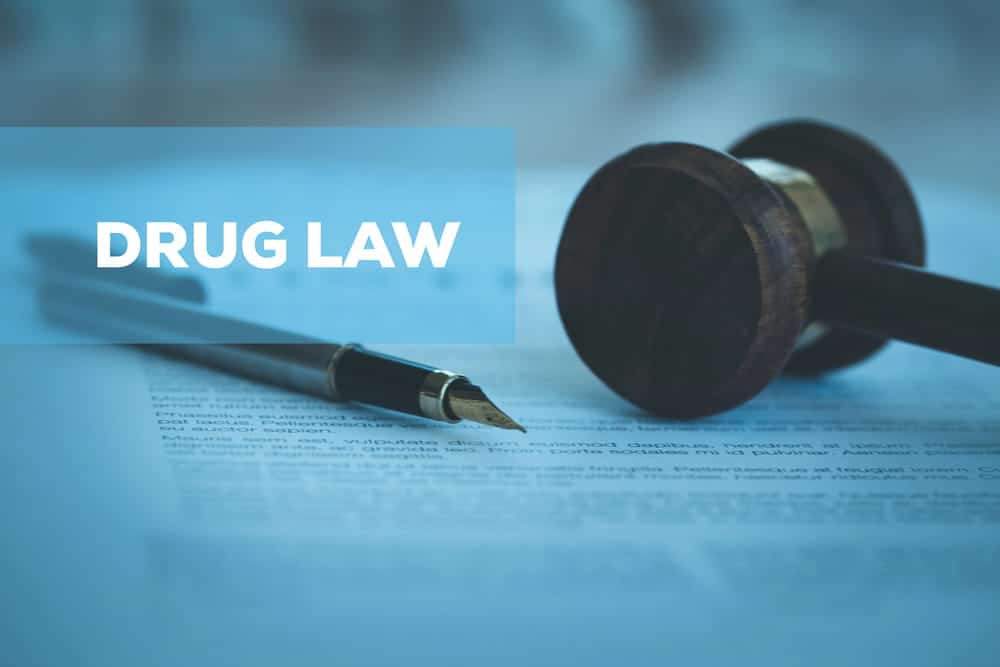 Image is of a gavel and legal document labeled drug law, illustrating regulations connected to marijuana laws in Lebanon